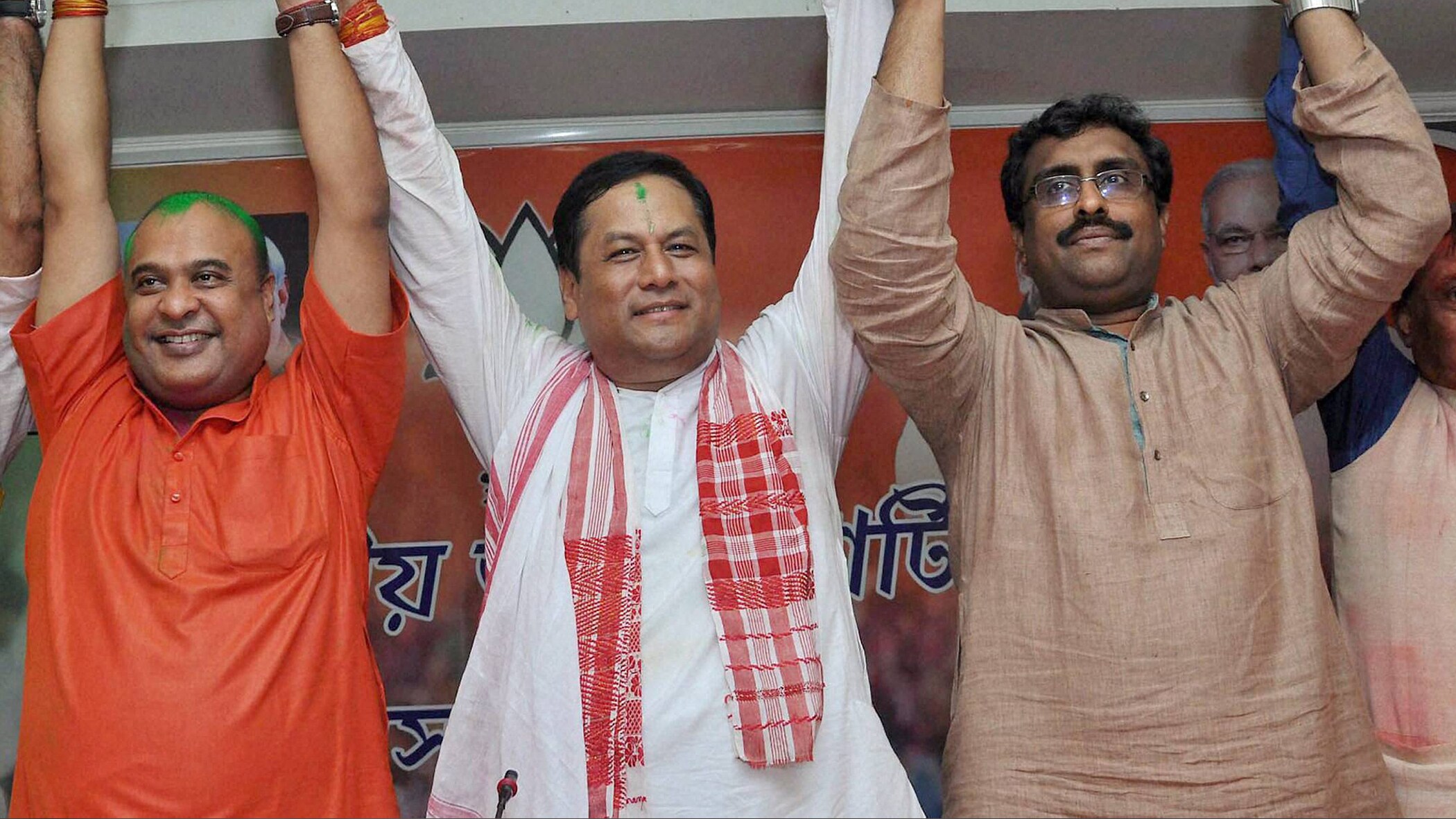 BJP chief ministerial candidate Sarbananda Sonowal (centre) along with Senior BJP leaders Ram Madhav (right) and Himanta Biswa Sarma (left) celebrating the party's thumping win the Assam Assembly polls at BJP Party head office in Guwahati on Thursday. (Photo: PTI)